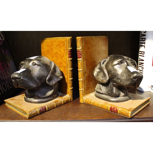 118 - A pair of bronze effect book-ends with dog heads and fashioned as leather book bindings