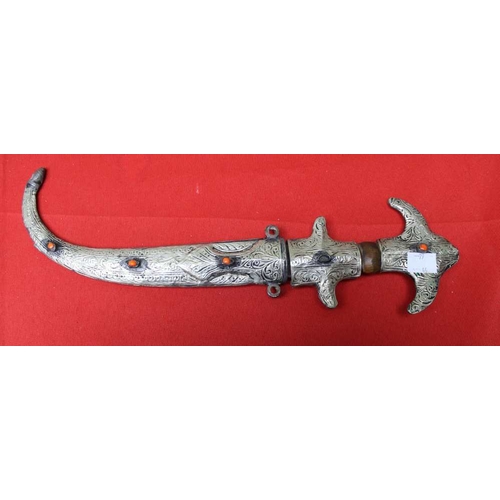 161 - A Middle Eastern white metal handled dagger in white metal covered scabbard, together with a pair of... 