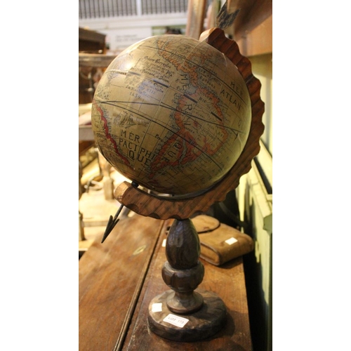 173 - A vintage globe on carved wooden stand