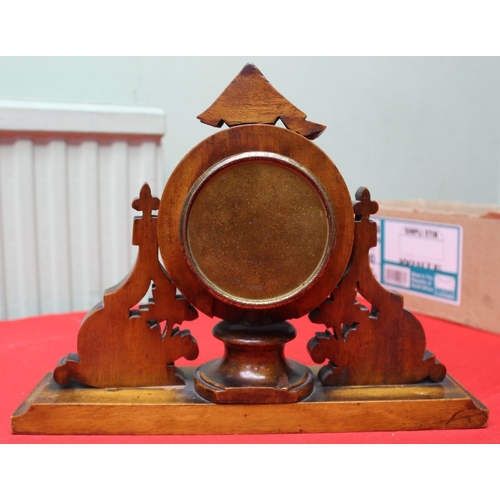 199 - A Black Forest style decorative carved wood framed mantel clock. c.1900