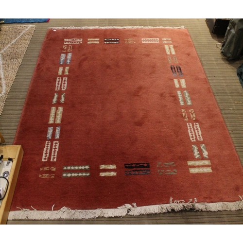 29 - A modern terracotta rug with a geometric design