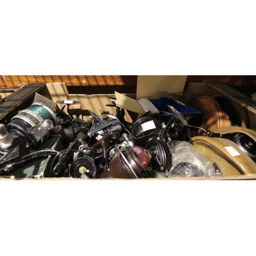 46 - A box containing a large selection of fishing reels, including two ABU 501 closed face and Mitchel