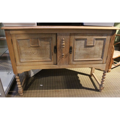 62 - A stripped wood sideboard, fitted two cupboard doors on barley twist legs, two keys but only one doo... 