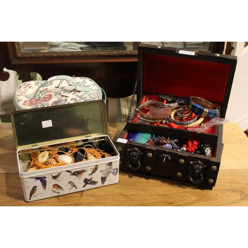 75 - A wooden jewellery box, a bag and a tin containing a good selection of costume jewellery