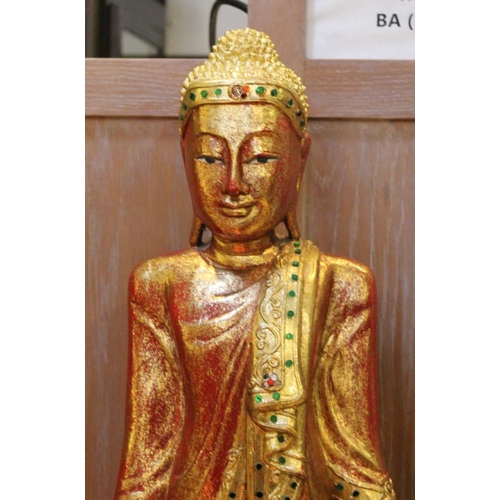 79 - A red lacquered wooden carved figure of a standing Buddha 82 cm high