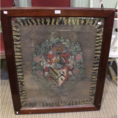 87 - A silk woven panel depicting a coat of arms in a double sided glazed oak frame