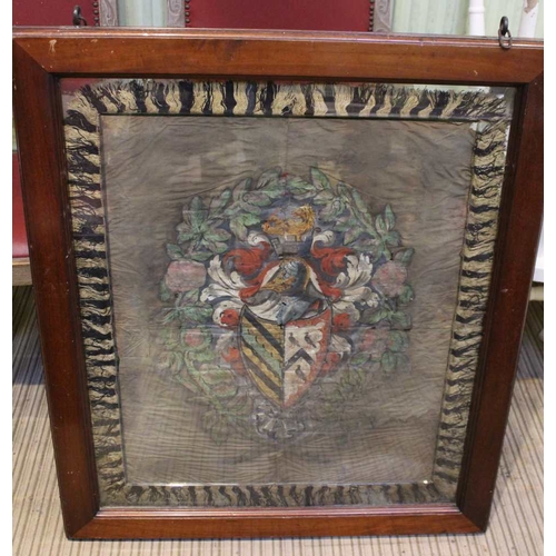 87 - A silk woven panel depicting a coat of arms in a double sided glazed oak frame