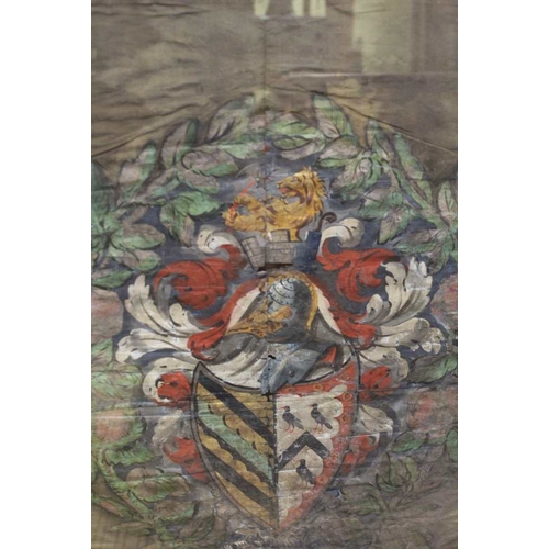 87 - A silk woven panel depicting a coat of arms in a double sided glazed oak frame