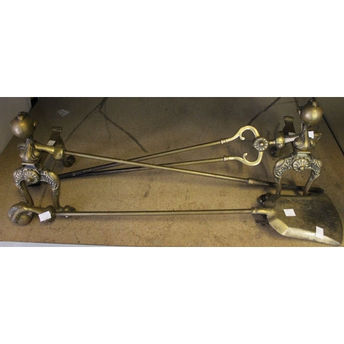 10 - A good pair of brass fire dogs with three fireside implements with ball and claw handles