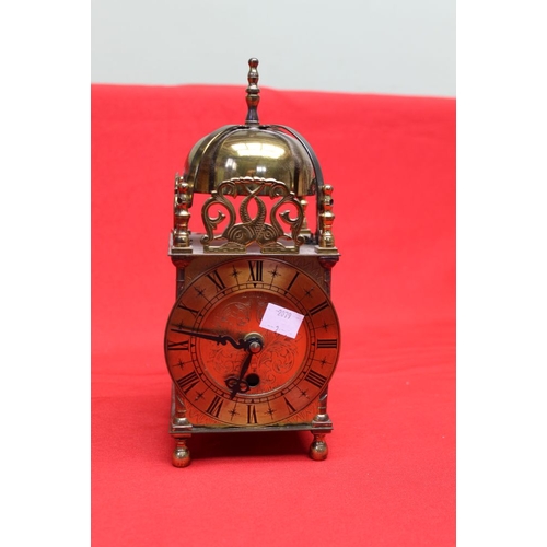 100 - A Smiths brass cased reproduction lantern clock with pierced and engraved decoration, 10.5cm dial wi... 