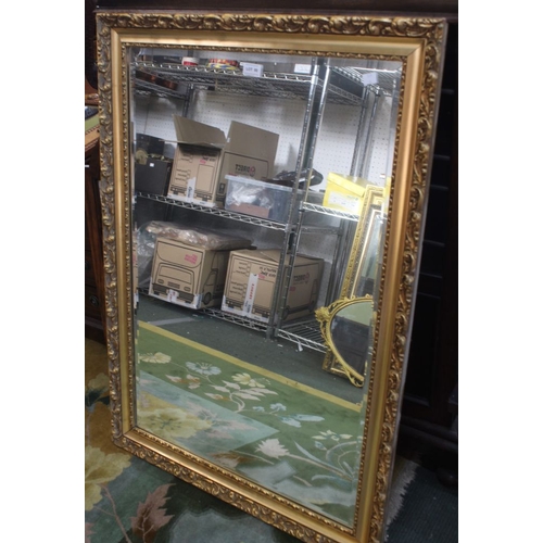 105 - A large modern bevel edged gilt framed wall mirror, plate size: 90cm x 60cm, overall with frame: 104... 