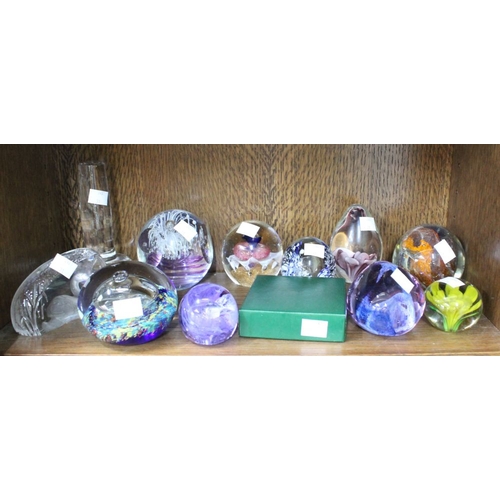 106 - A shelf of twelve Glass Paperweights Caithness etc