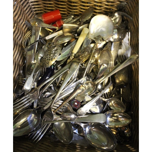 11 - A wicker basket containing a wide selection of plated flatware, cutlery, etc