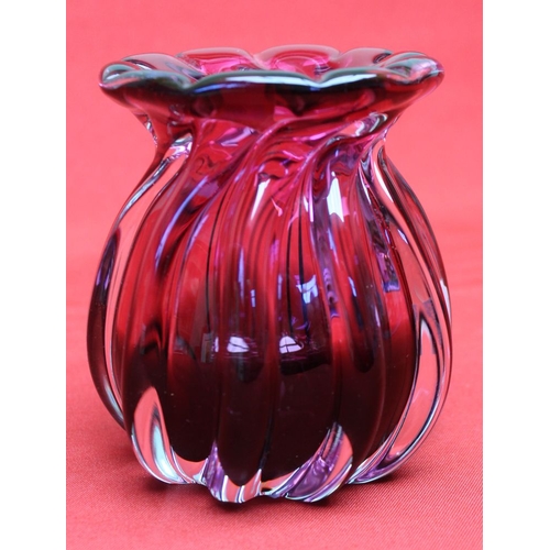 122 - A Bohemian cranberry glass vase of fluted form, bears paper label 12.5cm high