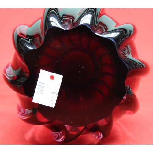 122 - A Bohemian cranberry glass vase of fluted form, bears paper label 12.5cm high