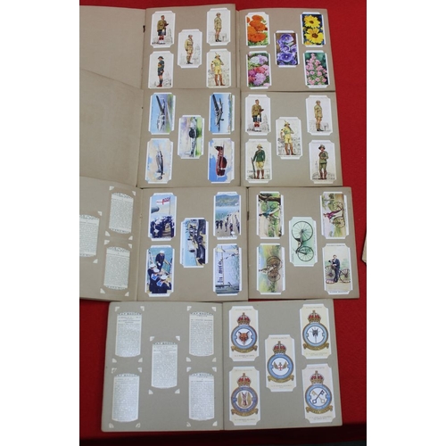 137 - Seven Wills Cigarette albums of cards (not stuck in) includes Cycling and RAF badges, together with ... 