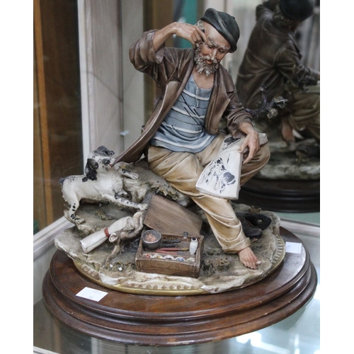 142 - A Capo di Monte ceramic figure of an artist with sketchbook and dog