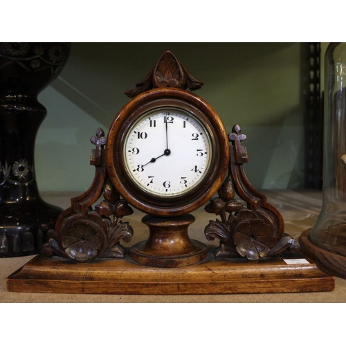 18 - A Black Forest style decorative carved wood framed mantel clock. c.1900