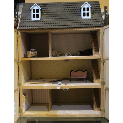 235 - A large dolls house in the form of a Georgian town house 88 cm in height x 62 x 38. Hinged frontage ... 