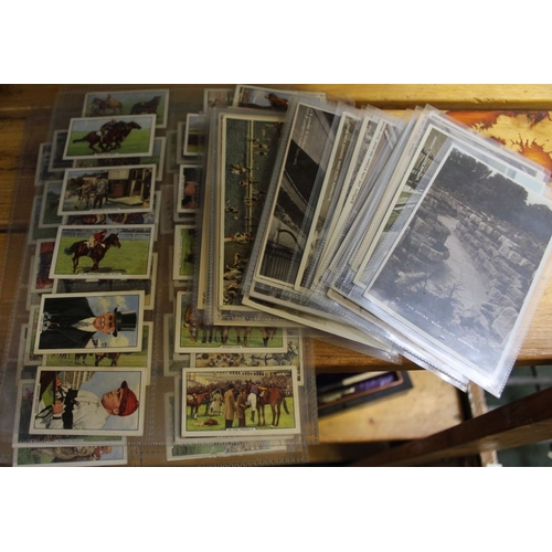 31 - A collection of Gallaher Racing scenes cigarette cards and various postcards