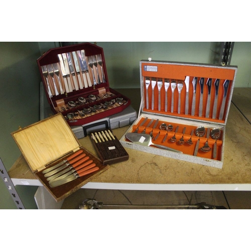 6 - A boxed set of kitchen knives with other boxed examples of canteens