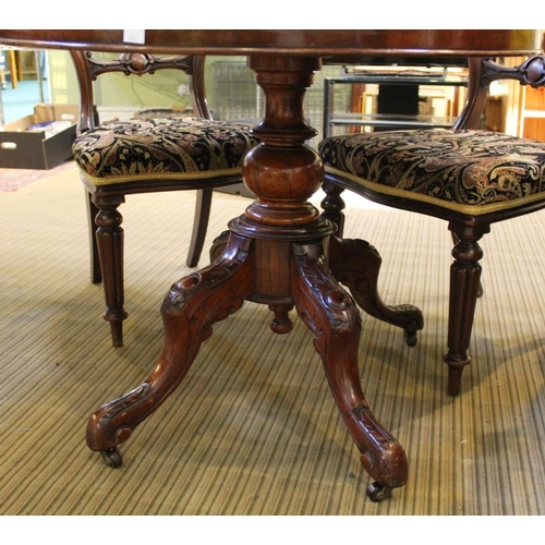 167 - A Victorian mahogany oval lou table, with snap top action, raised on turned stem with four cast supp... 