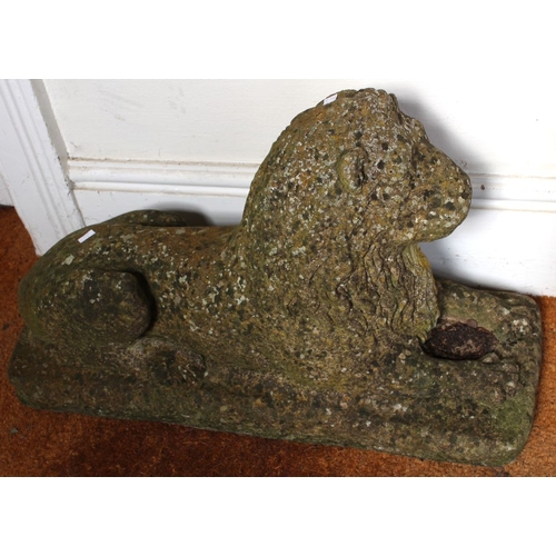 170 - A pair of well weathered recumbent cast lions