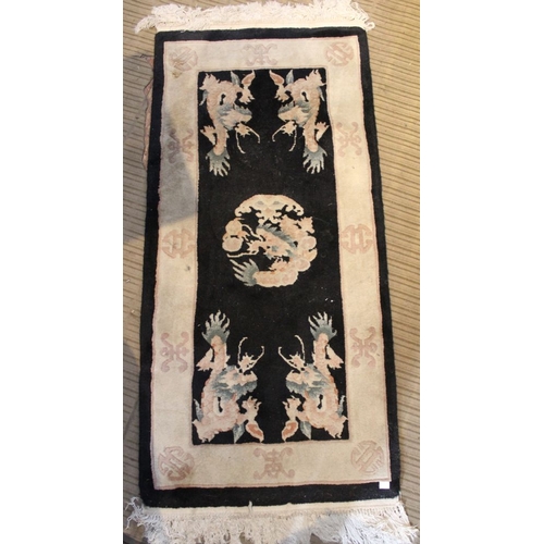 185 - Three Oriental inspired dark ground floor rugs