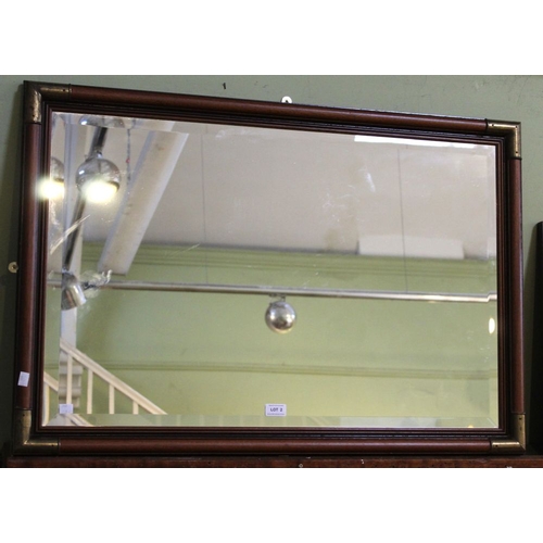 2 - A bevelled edge wall mirror in wood frame with brass corners