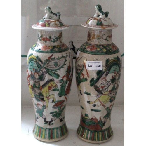 250 - A pair of Chinese ceramic lidded vases of baluster form, Warrior decoration painted in colours, lids... 