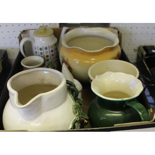 135 - A box containing a selection of domestic ceramic jugs, etc