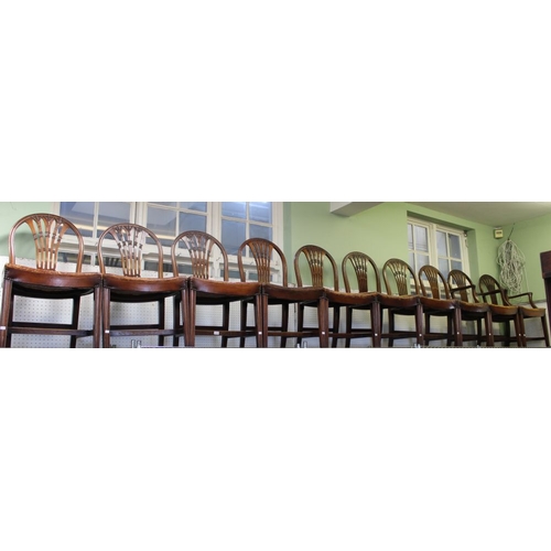 137 - A set of ten mahogany hoop back dining chairs with studded leather seats, 2 carvers