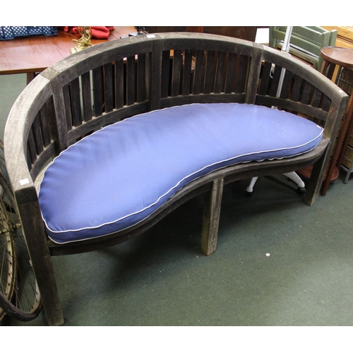 150 - A crescent shaped well weathered garden bench