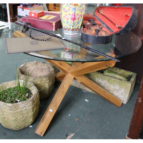 167 - A circular glass top table on substantial wooden base