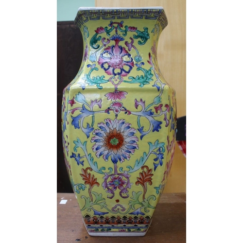 235 - A Chinese ceramic vase of hexagonal form, yellow ground, painted with flowers 43cm high