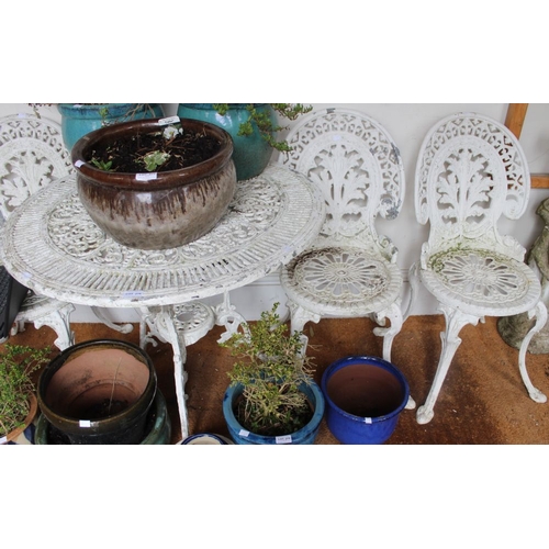 276 - A white painted metal circular garden table and four chairs