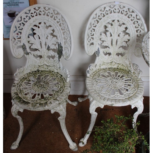 276 - A white painted metal circular garden table and four chairs