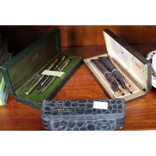 79 - A selection of Cross pens and pencils in two cases with a Hohner cased harmonica