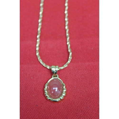 233 - A 10k gold neck chain with a cabochon pendent in an 18k frame, chain 7g