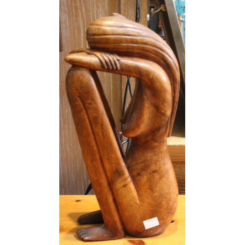 264 - A wood carved sculpture of a seated woman 36cm high