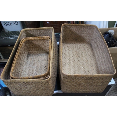 96 - Two woven rush covered storage baskets, with deep lids which double as further open baskets, largest... 