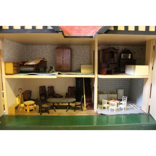 196 - A mid 20th century Triang manufactured dolls house to include furniture and associated literature