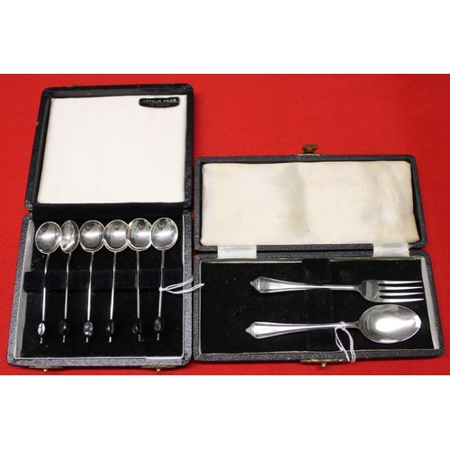 21 - A cased set of silver coffee bean spoons and another cased silver spoon and fork set