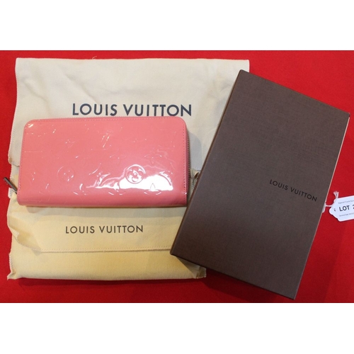 44 - A Louis Vuitton zip around ladies wallet, in patent pink 