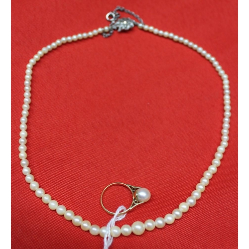 45 - An 18ct gold ring set a solitaire pearl, together with a graduated single strand pearl necklace (2)