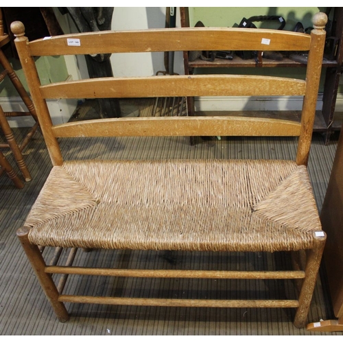 140 - A pine framed and rush seated two-seater indoor bench, 90cm wide x 100cm high x 40cm deep