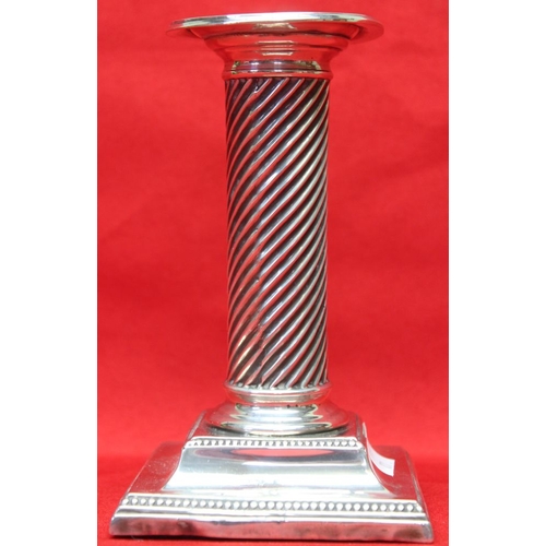 155 - A column design silver candlestick, raised on square stepped base, marks rubbed, 13.5cm high