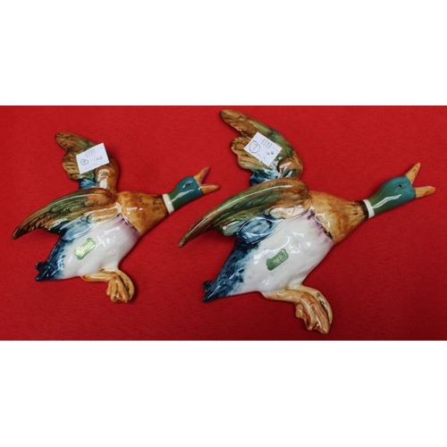 184 - A set of four Beswick pottery flying duck wall ornaments, No.596-1,2,3 and 4, three still bear the l... 