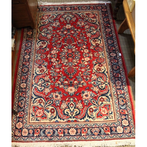 190 - A red ground geometric patterned floor rug