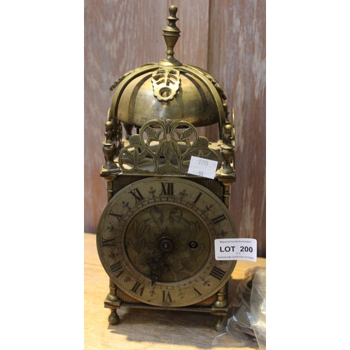 200 - A reproduction brass Lantern clock, fitted bell strike to top, silvered chapter ring with Roman nume... 